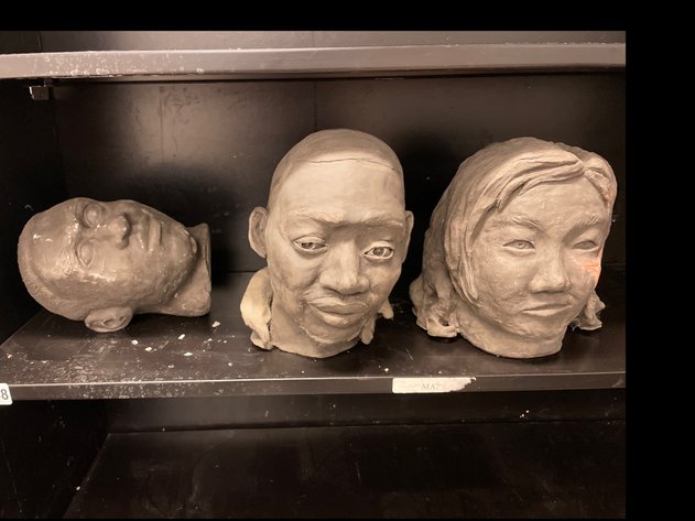 Three Human heads sculptures.